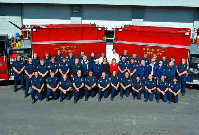 La Pine Rural Fire District staff pose for a photo in front of two fire engines. - COURTESY OF THE LA PINE RURAL FIRE DISTRICT