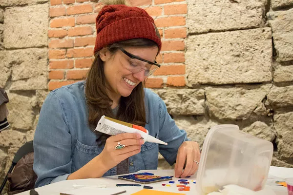 Director Sofia Kruz creates a tile during a recent mosaic workshop. - KEELY DAMARA