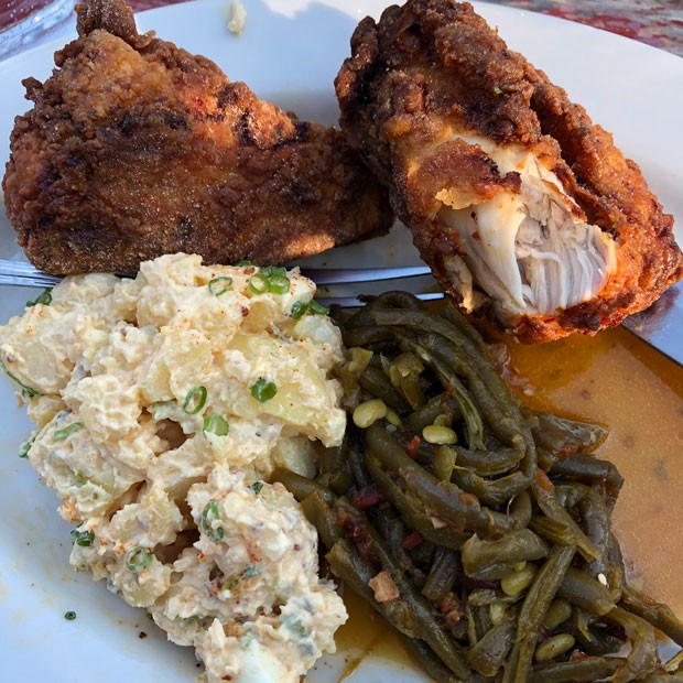 Left, Chef Maya Lovelace plates her signature fried chicken at the Suttle Lodge Dock Dinner July 8. - NICOLE VULCAN