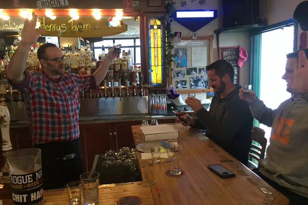 Two new members of the Rogue Nation club make their pledge at the Newport pub. - KEVIN GIFFORD