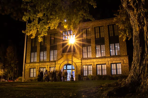 Tour-goers prepare for spooky stories in front of the Deschutes Historical Museum. - KEELY DAMARA