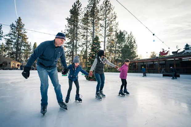 A family skates at the outdoor rink at the Seventh Mountain Resort last winter. - NATE WYETH
