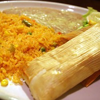 A TASTE OF MEXICAN HERITAGE: Tamales steamed in corn husks with rice and beans.