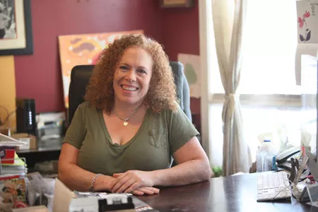 Amy ‘Miss Amy’ Goudy sits behind the desk in her Bugoudi House office. - JEFF HAHNE