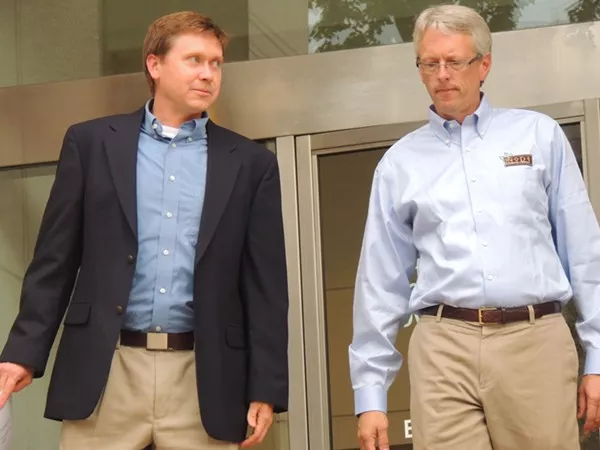 Attorney Russel Fergusson, left, and Todd Ford, co-owner of NoDa Brewery, leaving the City Council meeting Monday night.