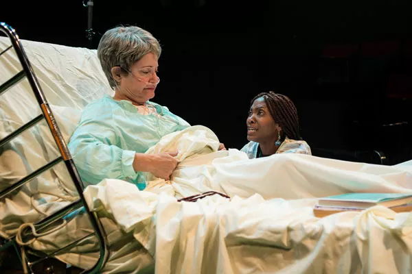 BEDSIDE MANNER: Maxine (Polly Adkins, left) and Tina (Nicole Watts) confer in Death Tax. - SHANNON J HAGER / XML PHOTOGRAPHY