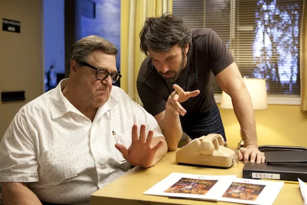 Ben Affleck (right) directs John Goodman on the set of Argo. - WARNER BROS.