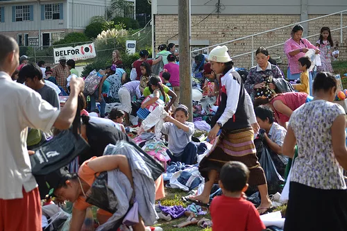 Birchcroft tenants sort clothes at a yard sale in front of the apartment complex.
