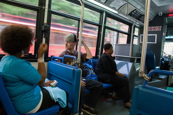 Chris Bode, center, relies on the bus to get to work after his car broke down a couple of months ago. (Photo: Joe Martin)