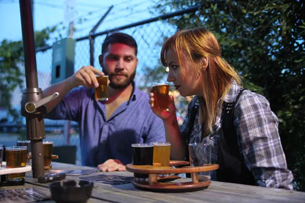 Chris Hendrickson and Dani Engle of Radio Lola sample the flavors of Triple C Brewing. - JEFF HAHNE