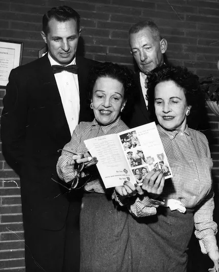 Daisy and Violet Hilton at Park n Shop, where they worked as produce clerks. In the left rear is Charles Reid, store owner, friend and the man who was responsible for providing the Hiltons with a funeral and burial plot.