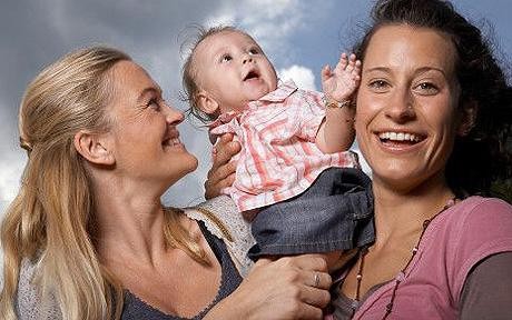 Debate this photo civilly: Happy lesbian couple with child, or nasty threat to all thats decent?