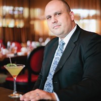 General Manager Aaron Ward with a signature cocktail