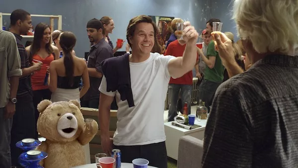 HE'LL OUTDRINK EVERY ONE OF US: Flash Gordon star Sam Jones (far right) does rum shots with Ted and John (Mark Wahlberg) in Ted. (Photo: Universal Pictures / Tippett Studio)