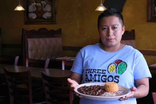 HOLY MOLE: Alejandra De la Cruz holds her signature dish.