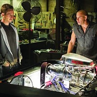 I WONDER HOW YOUR ENGINE FEELS: Brian O'Conner (Paul Walker, left) admires Dom Toretto's (Vin Diesel) hardware in Fast &amp; Furious. (Photo: Universal)