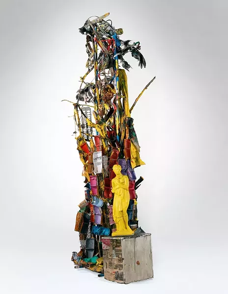 “Looking out the Windows (1992)”: Stuffed animals and little plastic play toys cascade down a wall in a jumbled wash of red, white and blue paint, wrapped and stilled in a netting of welded wire mesh, expanded metal grating, stranded wire and nylon rope. The objects appear both bound to the wall and falling simultaneously. The free fall is stayed for an instant as if caught in a freeze frame photograph.