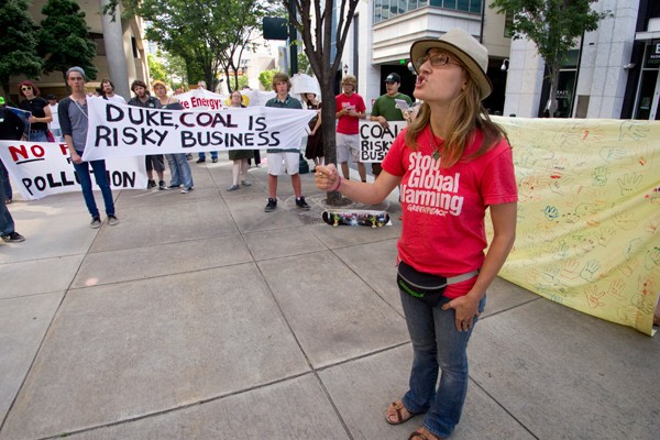 Members of Greenpeace helped organize the Duke Energy shareholder meeting protest on Thursday, where about 30 activists held signs and chanted in front of one of the company's Uptown buildings. (Photo by Grant Baldwin)