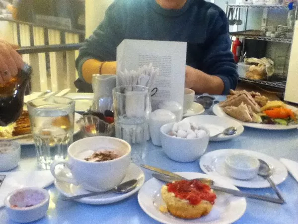 Taken at Willow Tea Rooms in Glasgows city centre, and the dishes in front of me are a cream scone with jam and a cappuccino