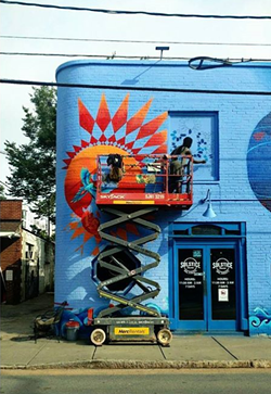 Nakima works on a piece of her mural at Solstice Tavern.