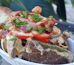 Chicken gouda potato with peppers and onions.