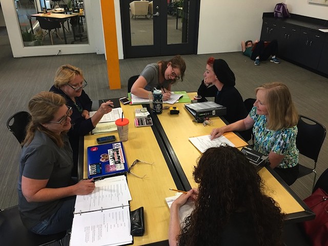 The production team at work [left to right]: Susan Hatem, Anne Lambert, Brenna Skinnon, Ramsey Lyric, Jackie Hohenstein and Barbara Berry [back to camera]. (photo courtesy of Charlotte's Off Broadway)
