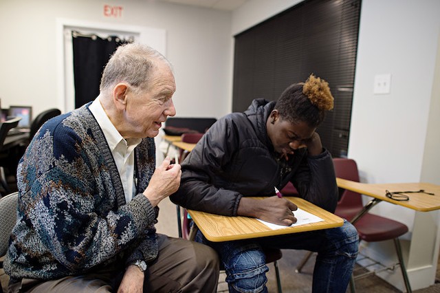 A volunteer at On Ramp works with a client. (Photo by The Beautiful Mess)