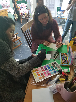 Lauren Kestner (left) and Hillary Belk collage together at a past workshop.