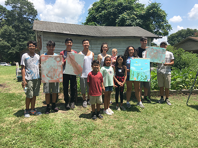 Lauren Kestner (center, holding baby) at a summer workshop with students from School of Jai, a local grassroots organization.