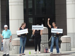 Protestors stood outside the courthouse holding "#JusticeForJonathan" signs following the announcement that the jury was deadlocked.