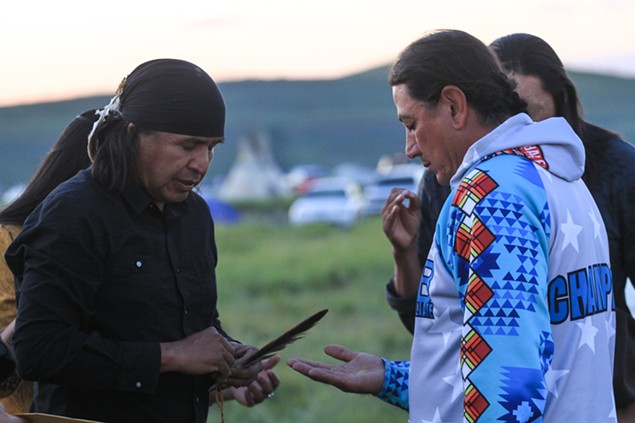 Wendsler Nosie, Sr., (left) prays with Standing Rock chairman David Archambault II during a 2016 visit to show solidarity with tribes and protesters opposing the Dakota Access Pipeline. - ALLIE FREDERICKS