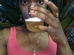 Ekua Adisa McRae with a Black Star Line beer.
