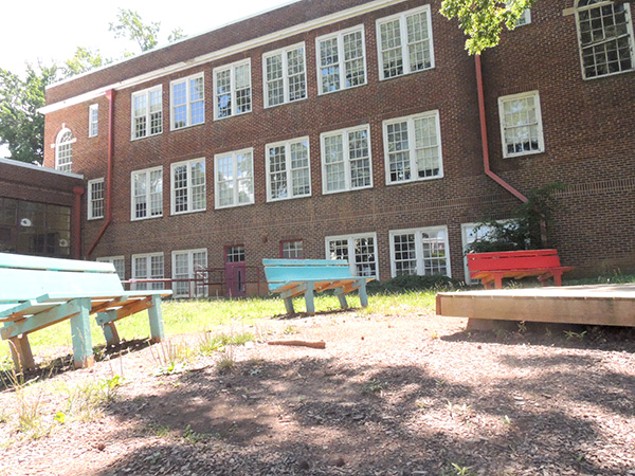 Benches sit empty outside the present-day Morgan School. (Photo by Ryan Pitkin)