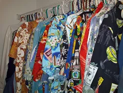 Beeler's closet full of TSC uniforms: dozens of gaudy Hawaiian shirts.