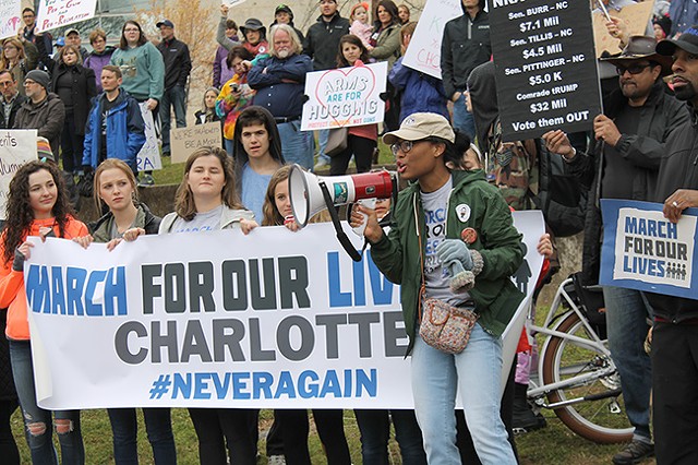 Rosemary Colen (with megaphone) addresses the crowd at Saturday’s March for Our Lives. Behind her stand fellow organizers Rebbeca Clarke (second from left), Maddie Syfert (third from left) and Carly Lerner (behind megaphone). (Photo by Alexandria Sands)