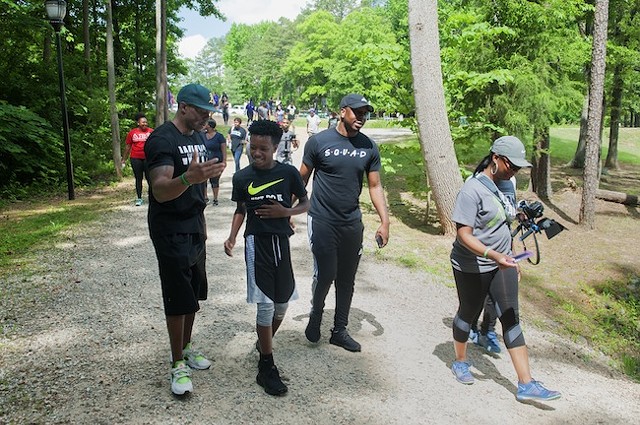 Miller [in green hat] and walkers at last year's Mental Health Awareness Walk at Park Road Park. (Photo by Jon Strayhorn)