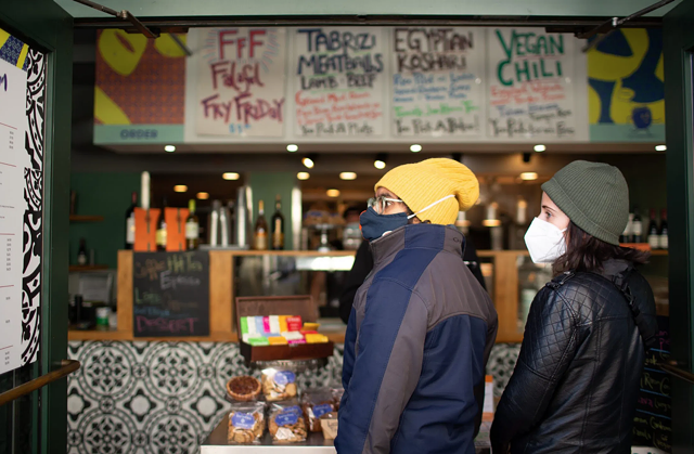 Owais Ahmed and Sophia Rafiqi of Chicago prepared to place a to-go order at Baba Nahm on November 17, 2020. The downtown Asheville restaurant's dining room remains closed. Colby Rabon / Carolina Public Press.
