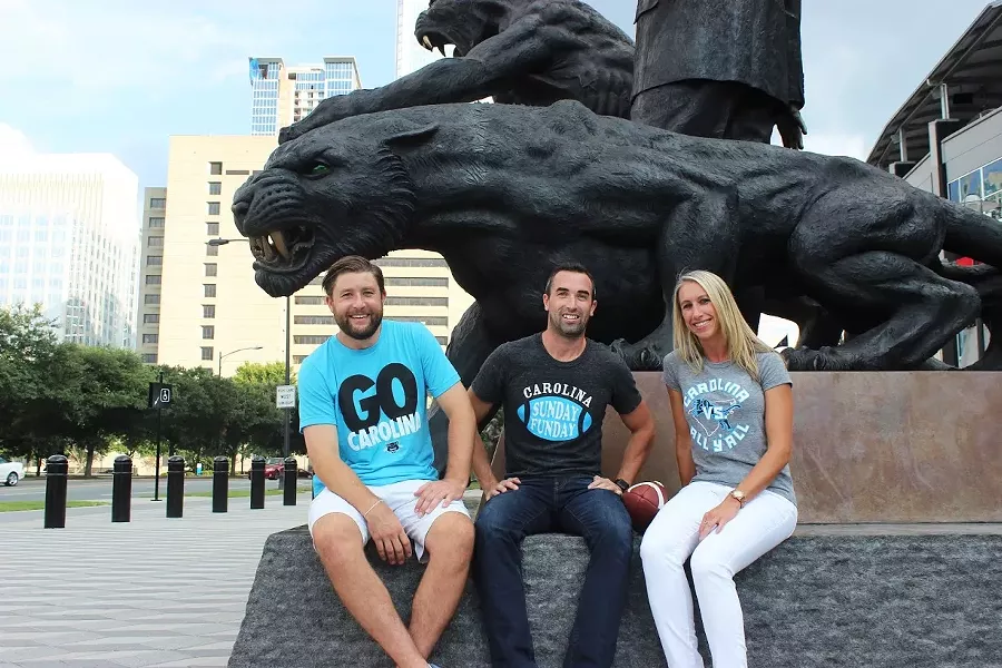 JD Harris (middle) shows off some Glory Days Apparel tees with friends.
