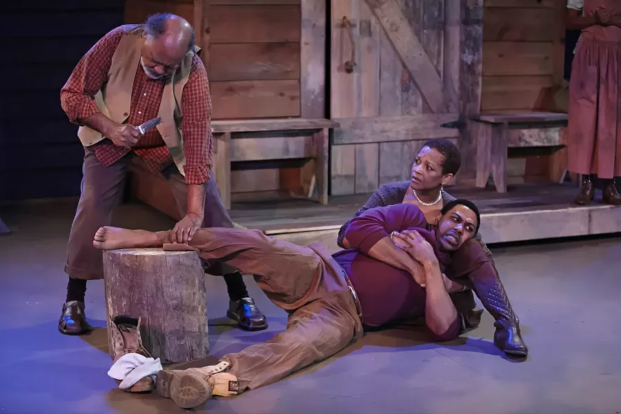 Jones, as Penny, cradles Jonavan Adams, as Hero, in 'Father Comes Home from the Wars.' John Price, at left, plays the Oldest Old Man. (George Hendricks Photography)