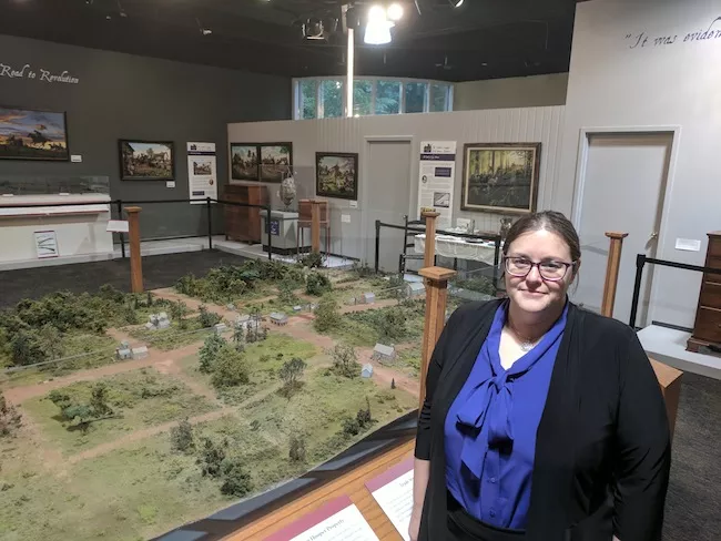 Adria Focht with a model of Uptown Charlotte, circa late 1700s.