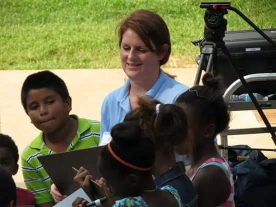 Heather Bise (far left) does math activities with kids in an east Charlotte apartment complex during an ourBRIDGE enrollment event. - PHOTO COURTESY OF HEATHER BISE