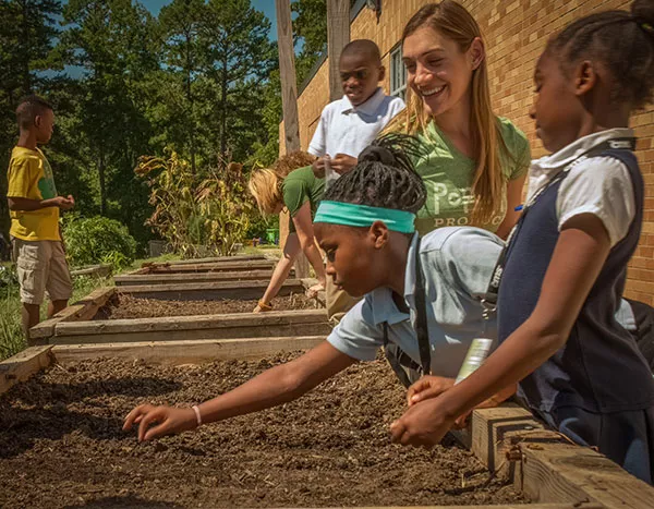 Amanda Zullo (in green) works with students at Shamrock Gardens Elementary School. - ALEX WALKER