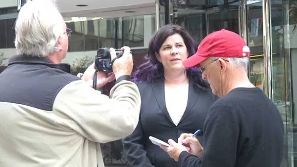 Charlotte School of Law student Margaret Kocaj speaks to reporters in front of the school. She’s demanding the school’s president and head dean be fired following recent investigations. - RHIANNON FIONN.