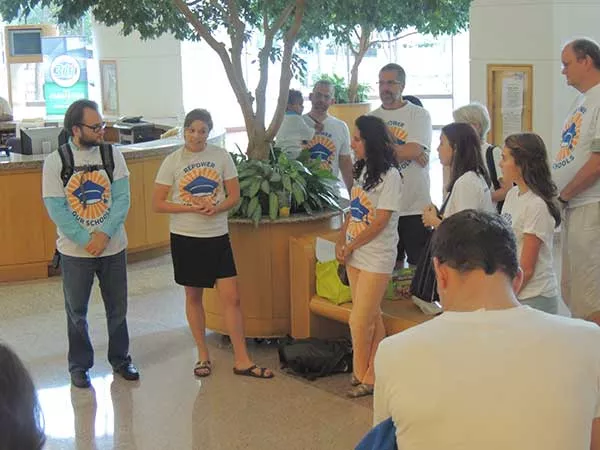 Hanna Mitchell (second from left) addresses a group of advocates at a CMS board meeting in August 2015, in Repower Our Schools’ early days. - RYAN PITKIN