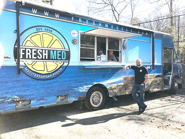 Fresh Med is a relatively new food truck that’s made a big splash. The owner, Tyler Lee, is standing; in the window is Chris Alves, the chef. - MICHAEL ROSEN