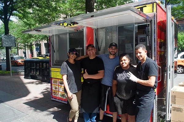 The Halal cart crew: Ansar (left) and Collado (center) with three employees. Photo by Allison Braden.