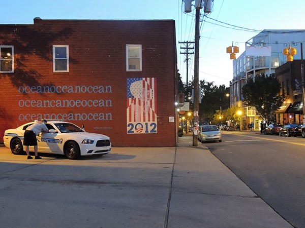 A police car hangs out in NoDa on May 31, the first night of foot patrols in the neighborhood.