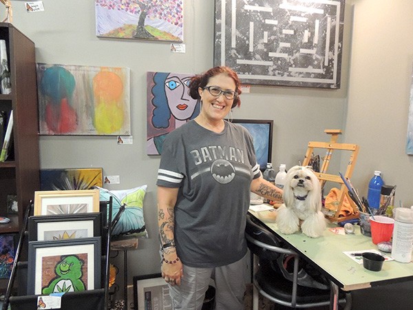 Kirsten Winger with her dog Gabi in her 'Flutterby Art' studio in CAL. (Photo by Ryan Pitkin)