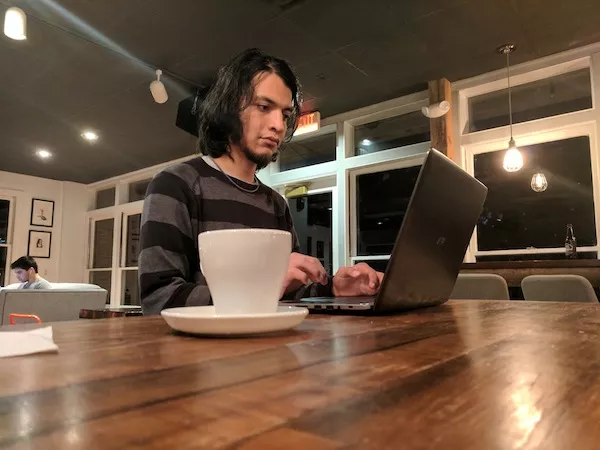 Carlos Miranda sits inside Summit Coffee on the Davidson College campus.