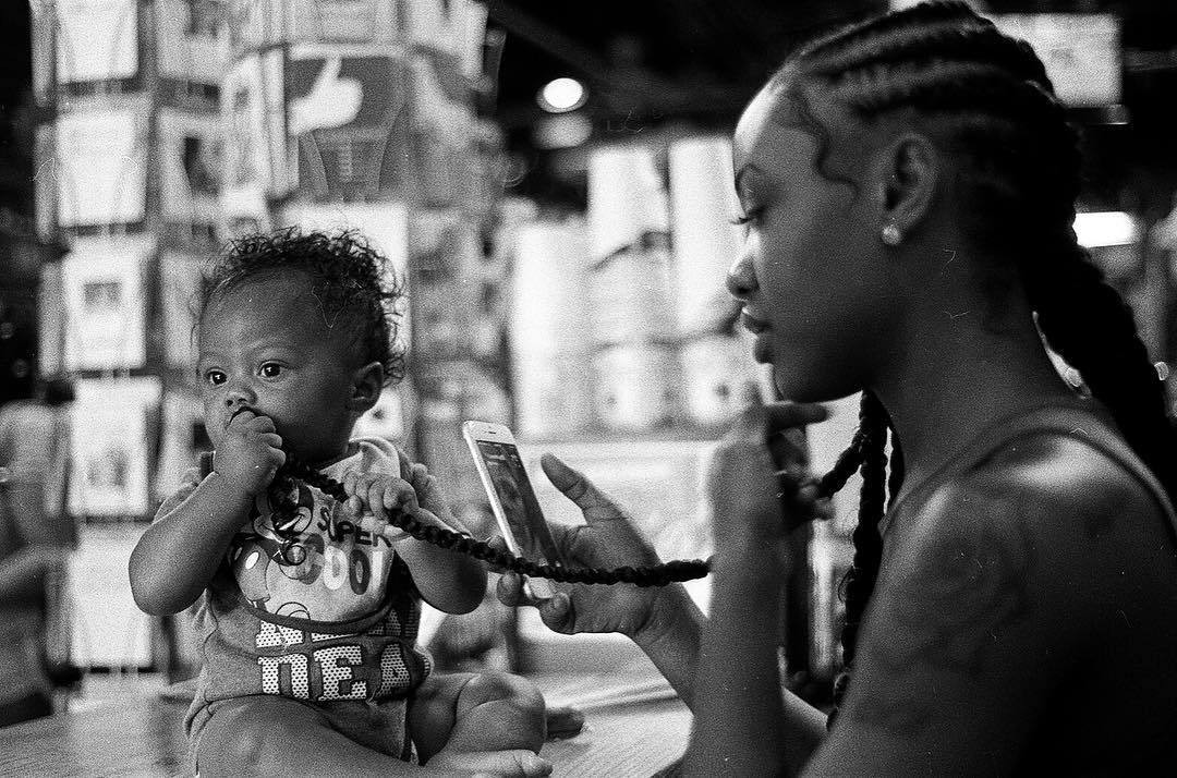 Real Charlotte Observer: Barnhardt's documentary photography: black and white, 35mm film from August 2017 of a moment at Common Market in Plaza Midwood.